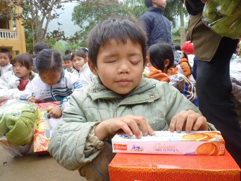 Em Bàn Văn Quý, học sinh lớp 1 trường Tiểu học Vinh Tiền bị mù cả hai mắt vui mừng với quà Tết mới được nhận